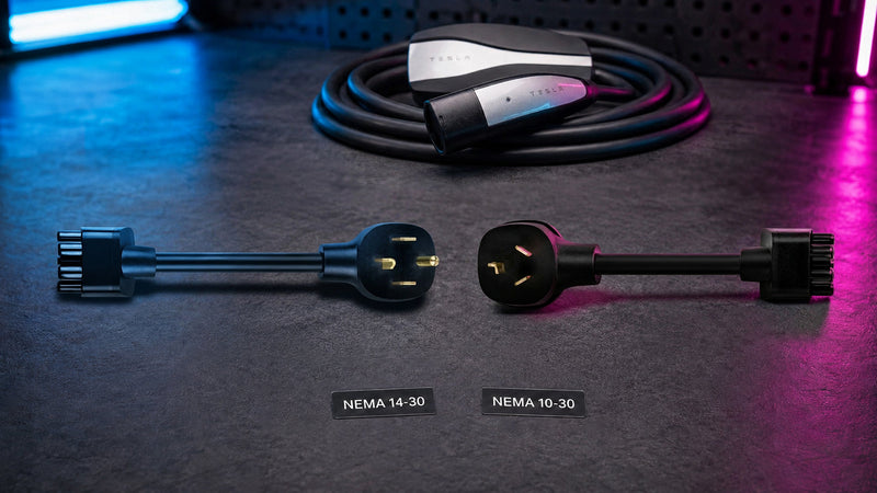 WenStorm Tesla NEMA 14-30 and 10-30 dryer outlet adapters shown side by side with a Tesla Gen 2 Mobile Connector in the background.