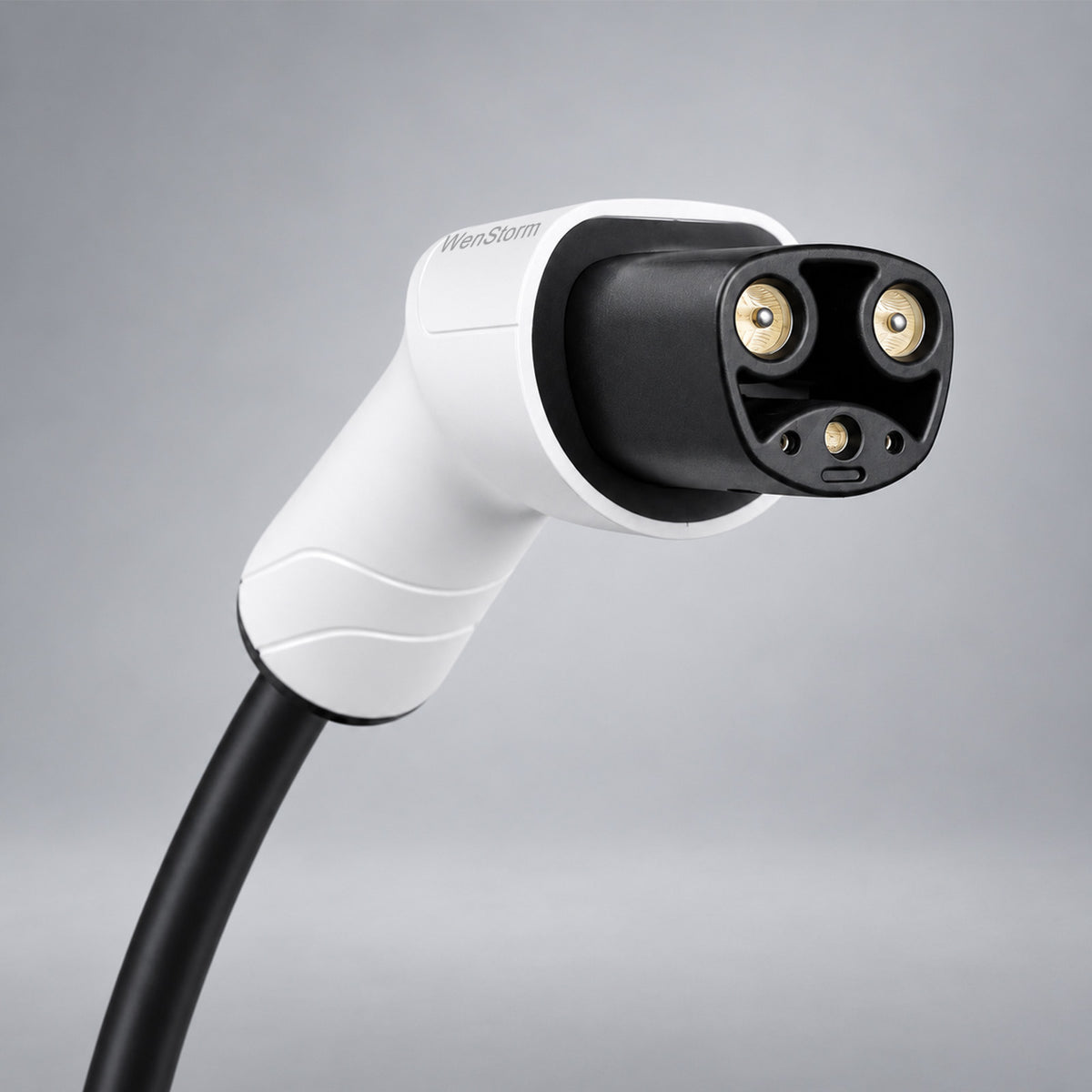 A close-up of a white and black WenStorm NACS extension cords with gold-plated pins